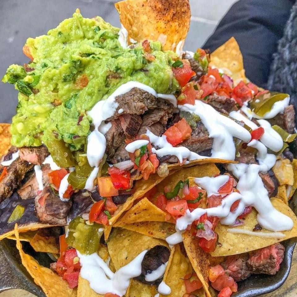 Guac Island Mexican Grill's loaded nachos with steak, guacamole, pico de gallo, and sour cream.